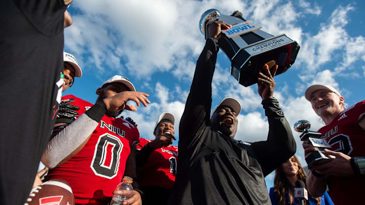 Northern Illinois Huskies head coach Thomas Hammock hoists the Camellia Bowl trophy as Arkansas State Red Wolves take on the Northern Illinois Huskies during the Camellia Bowl at Cramton Bowl in Montgomery, Ala., on Saturday, Dec. 23, 2023. Northern Illinois Huskies defeated Arkansas State Red Wolves 21-19.