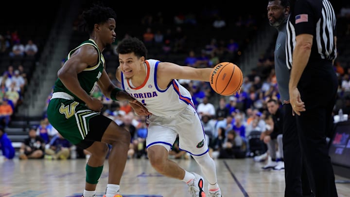 Florida Gators guard Walter Clayton Jr. (1) penetrates against South Florida Bulls guard Kasen Jennings (13) during the first half of an NCAA men’s basketball matchup Monday, Nov. 4, 2024 at VyStar Veterans Memorial Arena in Jacksonville, Fla. [Corey Perrine/Florida Times-Union]
