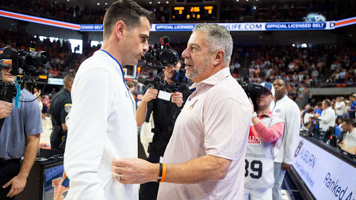 Florida Gators head coach Todd Golden and Auburn Tigers head coach Bruce Pearl talk before the game as Auburn Tigers take on Florida Gators at Neville Arena in Auburn, Ala., on Saturday, Feb. 8, 2025.
