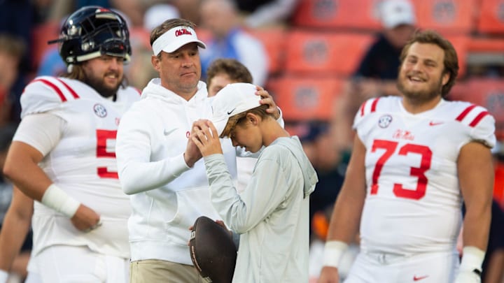 Mississippi Rebels head coach Lane Kiffin jokes with his son, Knox, during warm ups before Auburn Tigers take on Mississippi Rebels at Jordan-Hare Stadium in Auburn, Ala., on Saturday, Oct. 21, 2023.