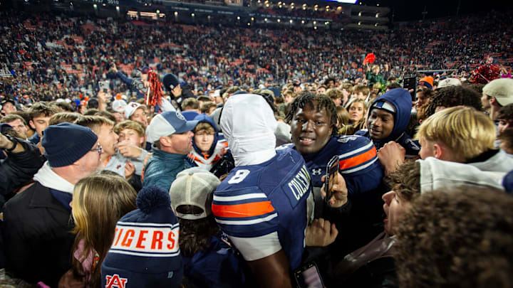Auburn Tigers wide receiver Cam Coleman (8) and defensive lineman Malik Blocton (47) celebrate with fans as Auburn Tigers take on Texas A&M Aggies at Jordan-Hare Stadium in Auburn, Ala., on Saturday, Sept. 7, 2024. Auburn Tigers defeated Texas A&M Aggies 43-41 in fourth overtime.