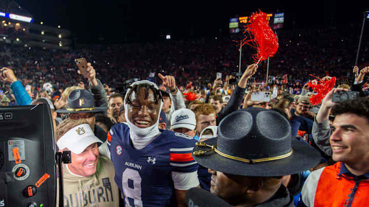 Auburn Tigers head coach Hugh Freeze and wide receiver Cam Coleman (8) hug after the game as Auburn Tigers take on Texas A&M Aggies at Jordan-Hare Stadium in Auburn, Ala., on Saturday, Sept. 7, 2024. Auburn Tigers defeated Texas A&M Aggies 43-41 in fourth overtime.