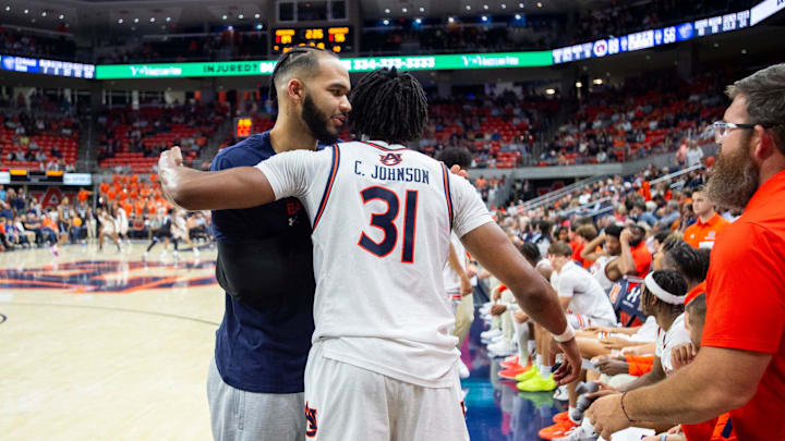 Auburn Tigers forward Johni Broome (4) hugs Auburn Tigers forward Chaney Johnson (31) as he checks out of the game as Auburn Tigers take on Georgia State Panthers at Neville Arena in Auburn, Ala., on Tuesday, Dec. 17, 2024. Auburn Tigers defeated Georgia State Panthers 100-59.