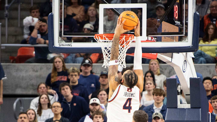 Auburn Tigers forward Johni Broome (4) dunks the ball as Auburn Tigers take on Arkansas Razorbacks at Neville Arena in Auburn, Ala., on Wednesday, Feb. 19, 2025. Auburn Tigers lead Arkansas Razorbacks 33-27 at halftime.