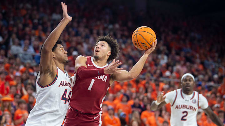 Alabama Crimson Tide guard Mark Sears (1) goes up for a layup on Auburn Tigers center Dylan Cardwell (44)