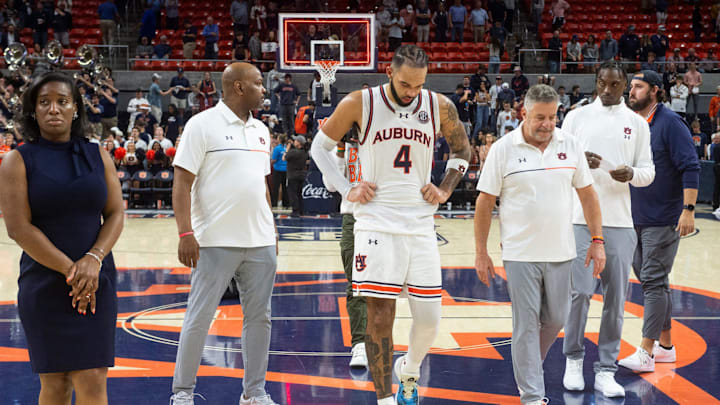 Auburn Tigers forward Johni Broome (4) and head coach Bruce Pearl leave the court after the game as Auburn Tigers take on Alabama Crimson Tide at Neville Arena in Auburn, Ala., on Saturday, March 8, 2025. Alabama Crimson Tide defeated Auburn Tigers 93-91 in overtime.