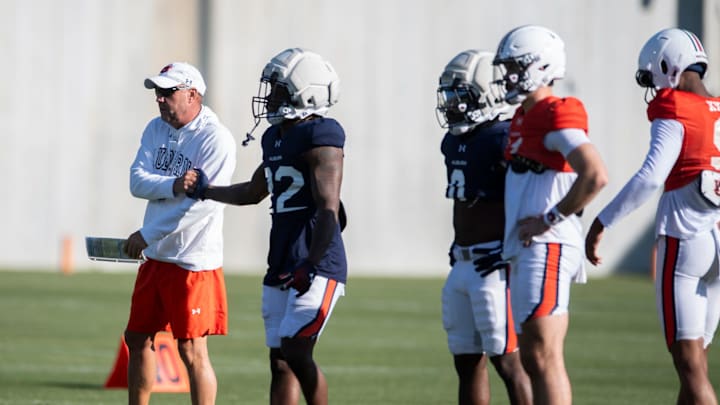 Auburn Tigers head coach Hugh Freeze shakes hands with running back Alvin Henderson (22) during football practice at Woltosz Football Performance Center in Auburn, Ala., on Thursday, April 10, 2025.