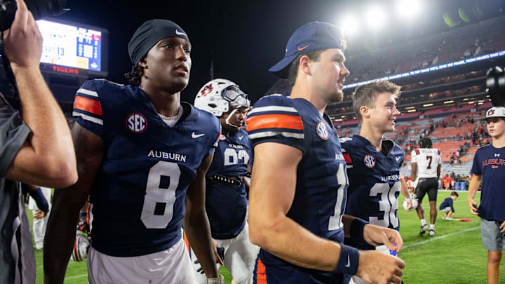 Auburn Tigers wide receiver Cam Coleman (8), defensive lineman Jay Hardy (92), quarterback Jackson Arnold (11), and kicker Alex McPherson (38) walk off the field together after the game as Auburn Tigers take on Ball State Cardinals at Jordan-Hare Stadium in Auburn, Ala. on Saturday, Sept. 6, 2025. Auburn Tigers defeated Ball State Cardinals 42-3.