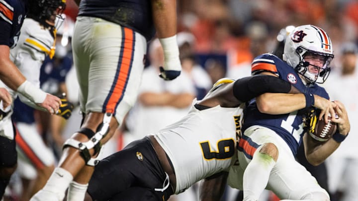 Auburn Tigers quarterback Jackson Arnold (11) is sacked by Missouri Tigers defensive end Zion Young (9) as Auburn Tigers take on Missouri Tigers at Jordan-Hare Stadium in Auburn, Ala. on Saturday, Oct. 18, 2025. Missouri Tigers defeated the Auburn Tigers 23-17 in 2OT.