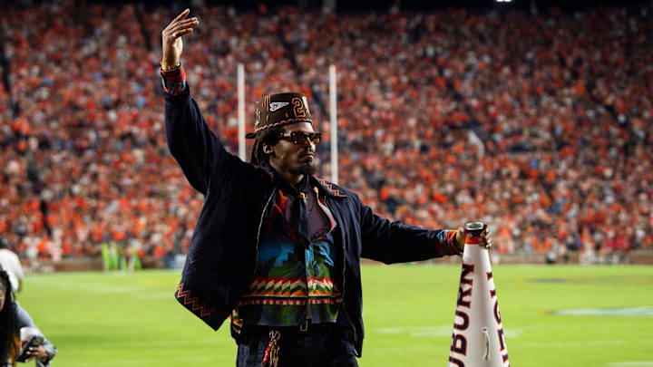 Former Auburn quarterback Cam Newton cheers on his team from the sideline as Auburn Tigers take on Georgia Bulldogs at Jordan-Hare Stadium in Auburn, Ala. on Saturday, Oct. 11, 2025. Auburn Tigers lead Georgia Bulldogs 10-3 at halftime.