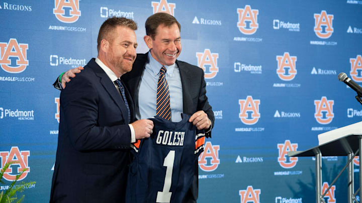 Auburn football head coach Alex Golesh and Auburn athletic director John Cohen pose for photos during his introductory press conference at Jordan-Hare Stadium in Auburn, Ala. on Monday, Dec. 1, 2025. Auburn football head coach Alex Golesh and Auburn athletic director John Cohen pose for photos during his introductory press conference at Jordan-Hare Stadium in Auburn, Ala. on Monday, Dec. 1, 2025.