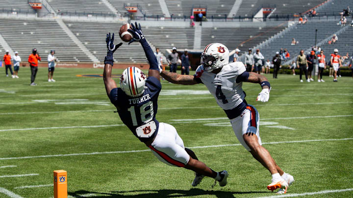 Auburn Tigers wide receiver Sam Turner (18) drops a pass defined by Auburn Tigers defensive back Kayin Lee (4) during Auburn Tigers A-Day football practice at Jordan-Hare Stadium in Auburn, Ala., on Saturday, April 12, 2025.