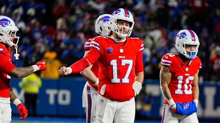 Buffalo Bills running back James Cook and quarterback Josh Allen fist bump after a play against the New England Patriots.