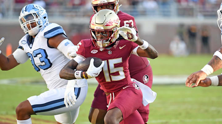 Nov 2, 2024; Tallahassee, Florida, USA;  Florida State Seminoes receiver Lawayne McCoy (15) runs the ball for a two point conversion against the North Carolina Tarheels in the first quarter at Doak S. Campbell Stadium. Mandatory Credit: Robert Myers-Imagn Images