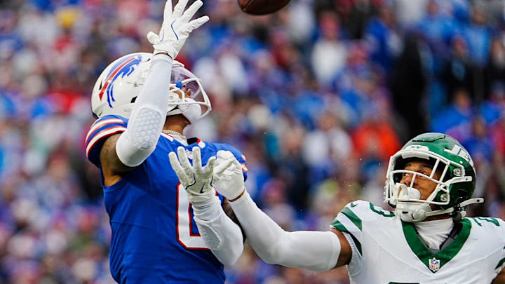 Buffalo Bills wide receiver Keon Coleman (0) catches a pass beating New York Jets cornerback Isaiah Oliver (23) to the ball during first half action at the Bills home game against the New York Jets at Highmark Stadium in Orchard Park on Dec. 29, 2024.