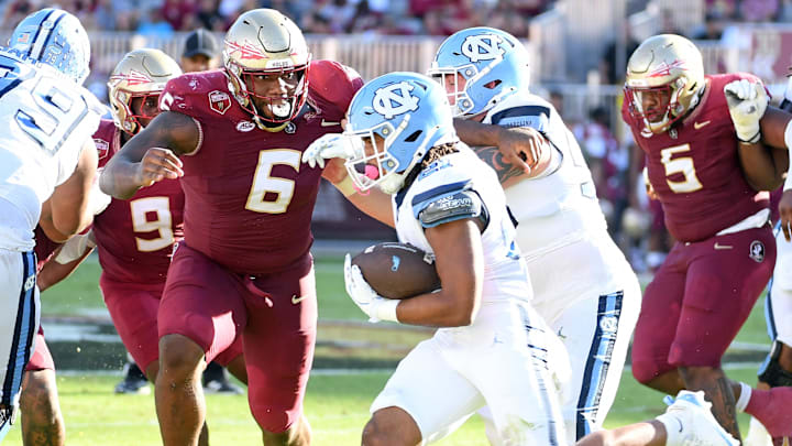 Nov 2, 2024; Tallahassee, Florida, USA;  Florida State Seminoles defensive tackle Darrell Jackson Jr (6) pursues North Carolina Tarheels running back Davion Gause (21) in the second quarter at Doak S. Campbell Stadium. Mandatory Credit: Robert Myers-Imagn Images