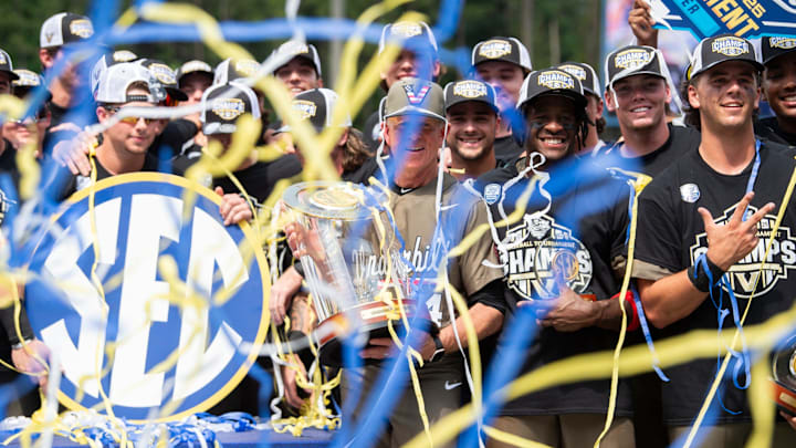 Vanderbilt Commodores head coach Tim Corbin and his team celebrate with the championship trophy as Ole Miss Rebels take on Vanderbilt Commodores during the SEC baseball tournament championship game at Hoover Met in Birmingham, Ala., on Sunday, May 25, 2025. Vanderbilt Commodores defeated Ole Miss Rebels 3-2.
