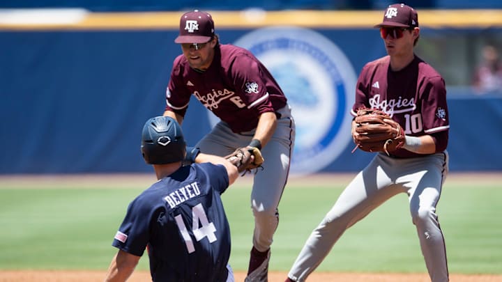 Auburn Tigers' Cade Belyeu (14) is tagged out by Texas A&M Aggies' Kaeden Kent (6) as Auburn Tigers take on Texas A&M Aggies during the SEC baseball tournament at Hoover Met in Birmingham, Ala., on Thursday, May 22, 2025. Texas A&M Aggies defeated Auburn Tigers 3-2.