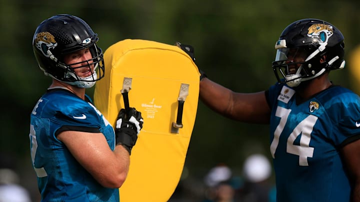 Jacksonville Jaguars offensive tackle Walker Little (72) and offensive tackle Cam Robinson (74) trade off a blocking pad during the third day of an NFL football training camp practice Friday, July 26, 2024 at EverBank Stadium’s Miller Electric Center in Jacksonville, Fla.