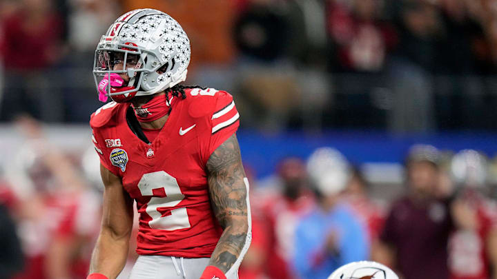 Ohio State Buckeyes wide receiver Emeka Egbuka (2) celebrates after making a catch against Texas Longhorns defensive back Jaylon Guilbeau (3) and linebacker Anthony Hill Jr. (0) in the first quarter of the Cotton Bowl Classic during the College Football Playoff semifinal game at AT&T Stadium in Arlington, Texas on January, 10, 2025.