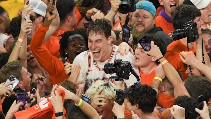 Feb 8, 2025; Clemson, South Carolina, USA; Clemson Tigers sophomore center Viktor Lakhin (0) smiles with fans who rushed the court to celebrate the win over Duke Blue Devils at Littlejohn Coliseum.  