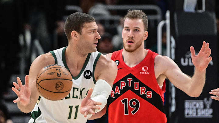 Mar 19, 2023; Milwaukee, Wisconsin, USA; Milwaukee Bucks center Brook Lopez (11) looks to pass the ball against Toronto Raptors center Jakob Poeltl (19) in the fourth quarter at Fiserv Forum. Mandatory Credit: Benny Sieu-USA TODAY Sports Mar 19, 2023; Milwaukee, Wisconsin, USA; Milwaukee Bucks center Brook Lopez (11) looks to pass the ball against Toronto Raptors center Jakob Poeltl (19) in the fourth quarter at Fiserv Forum. Mandatory Credit: Benny Sieu-USA TODAY Sports