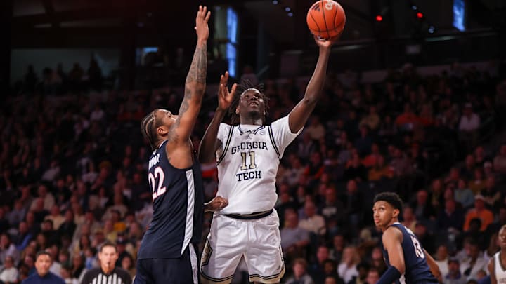 Jan 20, 2024; Atlanta, Georgia, USA; Georgia Tech Yellow Jackets forward Baye Ndongo (11) shoots past Virginia Cavaliers forward Jordan Minor (22) in the second half at McCamish Pavilion. Mandatory Credit: Brett Davis-Imagn Images

