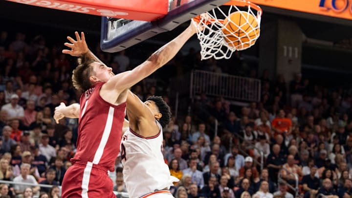 Alabama Crimson Tide forward Grant Nelson (4) dunks over Auburn Tigers center Dylan Cardwell (44) as Auburn Tigers take on Alabama Crimson Tide at Neville Arena in Auburn, Ala., on Saturday, March 8, 2025. Alabama Crimson Tide lead Auburn Tigers 45-42 at halftime. Alabama Crimson Tide forward Grant Nelson (4) dunks over Auburn Tigers center Dylan Cardwell (44) as Auburn Tigers take on Alabama Crimson Tide at Neville Arena in Auburn, Ala., on Saturday, March 8, 2025. Alabama Crimson Tide lead Auburn Tigers 45-42 at halftime.