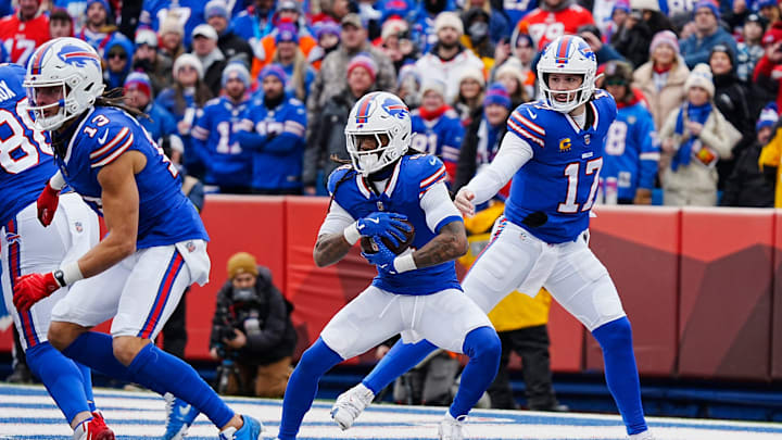Buffalo Bills quarterback Josh Allen hands the ball off to Buffalo Bills running back James Cook during the first half of the Buffalo Bills wild card game against the Denver Broncos. Buffalo Bills quarterback Josh Allen hands the ball off to Buffalo Bills running back James Cook during the first half of the Buffalo Bills wild card game against the Denver Broncos.