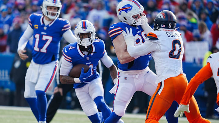 Buffalo Bills running back James Cook (4) runs past teammate Buffalo Bills tight end Dawson Knox (88) who blocks Denver Broncos linebacker Jonathon Cooper (0) Buffalo Bills running back James Cook (4) runs past teammate Buffalo Bills tight end Dawson Knox (88) who blocks Denver Broncos linebacker Jonathon Cooper (0)