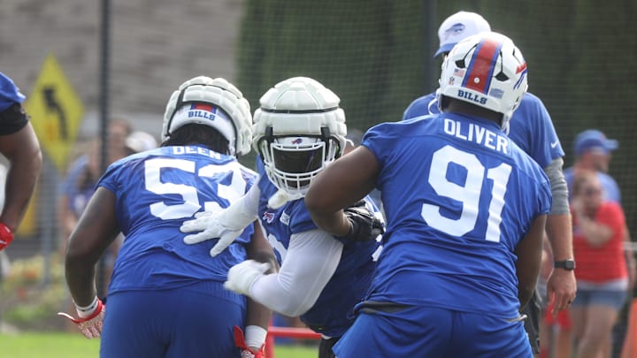 Bills DeShawn Williams tries to squeeze between Branson Deen and Ed Oliver during Bills training camp at St. John Fisher University in Pittsford, NY on August 8, 2024.