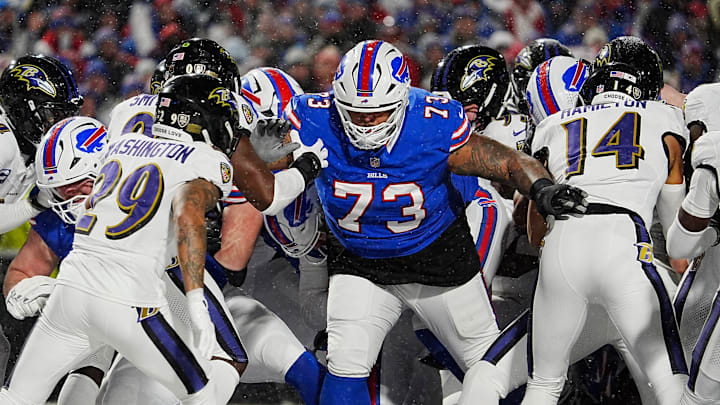 Buffalo Bills Dion Dawkins blocks for quarterback Josh Allen, behind him, who sneaks in for a touchdown during first half action at the Buffalo Bills divisional game against the Baltimore Ravens at Highmark Stadium in Orchard Park on Jan. 19, 2025.