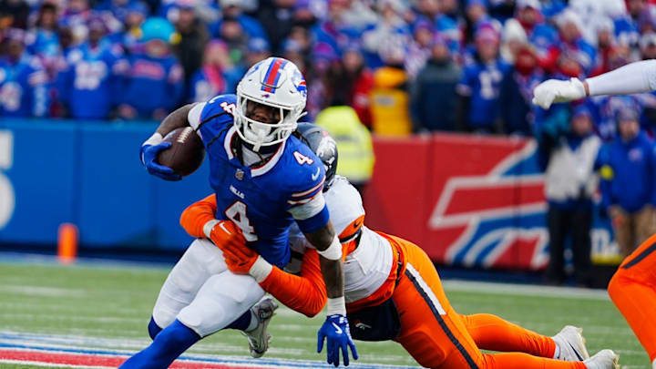 Buffalo Bills running back James Cook gets taken down by Denver Broncos linebacker Dondrea Tillman.