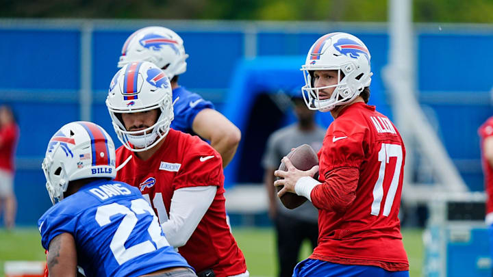 Buffalo Bills quarterback Josh Allen gets ready to throw to a receiver while back up quarterback Mitchell Trubisky hands off the ball to Ray Davis during their voluntary workout at their practice facility on May 27, 2025.