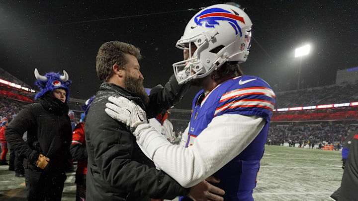 Buffalo Bills quarterback Josh Allen comes to the sideline to greet former Bills quarterback Ryan Fitzpatrick during warm ups before the Buffalo Bills divisional game against the Baltimore Ravens at Highmark Stadium in Orchard Park on Jan. 19, 2025. Buffalo Bills quarterback Josh Allen comes to the sideline to greet former Bills quarterback Ryan Fitzpatrick during warm ups before the Buffalo Bills divisional game against the Baltimore Ravens at Highmark Stadium in Orchard Park on Jan. 19, 2025.