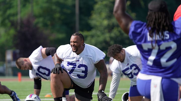 Buffalo Bills offensive tackle Dion Dawkins laughs after teammate’s comment as they stretch before practice t the Buffalo Bills training camp at St. John Fisher University in Pittsford on July 24, 2025.