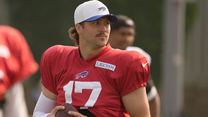 Buffalo Bills quarterback Josh Allen warms up with the other quarterbacks before practice begins at Bills Training Camp. Buffalo Bills quarterback Josh Allen warms up with the other quarterbacks before practice begins at Bills Training Camp.