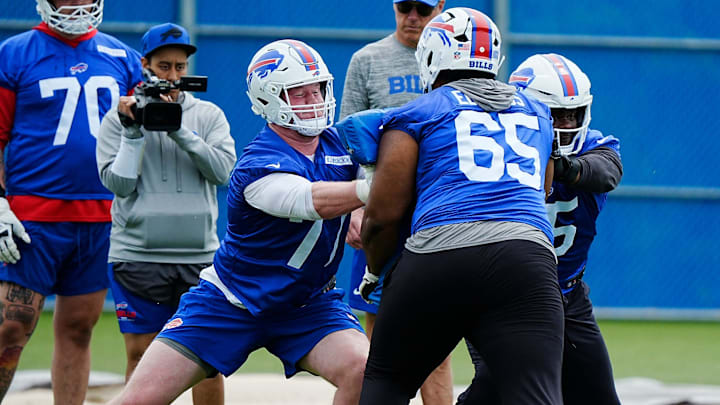 Buffalo Bills Chase Lundt blocks Mike Edwards with help from Richard Gouraige during their voluntary workout at their practice facility on May 27, 2025.