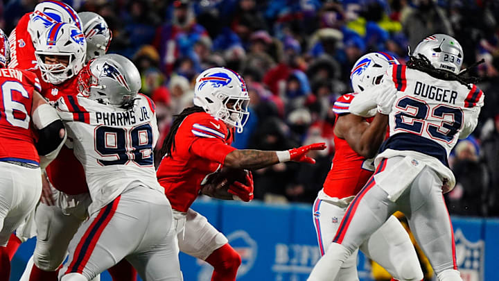Buffalo Bills running back James Cook finds an opening to run through will the ball during second half action.