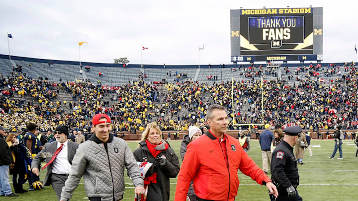 Ohio State Buckeyes head coach Urban Meyer walks with his family after beating Michigan Wolverines 31-20 after their game at Michigan Stadium on November 25, 2017.