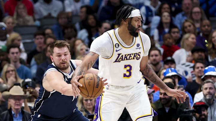 Feb 26, 2023; Dallas, Texas, USA;  Dallas Mavericks guard Luka Doncic (77) tries to knock the ball away from Los Angeles Lakers forward Anthony Davis (3) during the first quarter at American Airlines Center. Mandatory Credit: Kevin Jairaj-Imagn Images