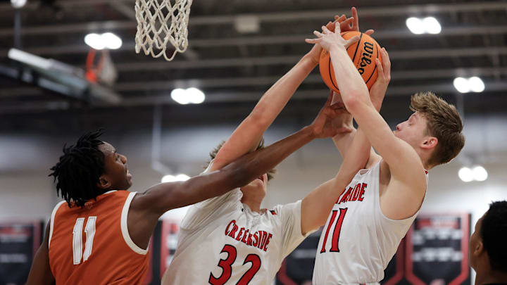 Tocoi Creek's Tyson Gilbert (11), Creekside's Nolan Nelson (32) and Yussef Elmaadawy (11) vie for the ball during the first quarter Thursday, Jan. 23, 2025 at Creekside High School in St. Johns, Fla. The Creekside Knights held off the Tocoi Creek Toros 59-56.
