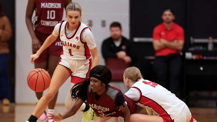 Madison County's Tahj Dobson (5), center, loses the ball against Hilliard's Alyssa Hallman (15), right, as Molly Dean (1) looks on during the third quarter of an FHSAA Region 3-Rural high school girls basketball semifinal Thursday, Feb. 13, 2025 at Hilliard Middle-Senior High School in Hilliard, Fla. Hilliard defeated Madison County 65-39.