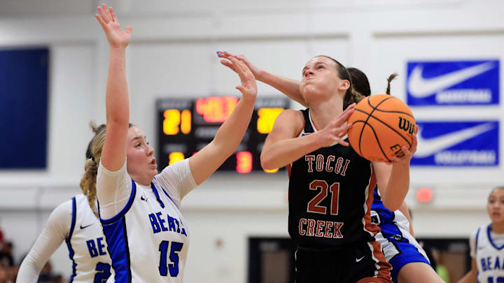 Tocoi Creek's Audrey Beyer (21) drives the lane against Bartram Trail's Alana Larson (15) during the second quarter of the District 3-6A girls basketball final Friday, Feb. 7, 2025 at Bartram Trail High School in St. Johns, Fla. The Tocoi Creek Toros defeated the Bartram Trail Bears 52-37.