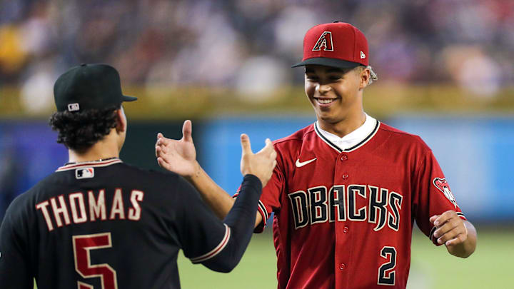 Diamondbacks Draft Druw Jones, right, shakes hands with Arizona Diamondbacks center fielder Alek Thomas (5), left, after throwing the opening pitch before the game against the Washington Nationals at Chase Field on Saturday, July 23, 2022, in Phoenix.

Uscp 7lzxvqcipg7dt8x01rk2 Original