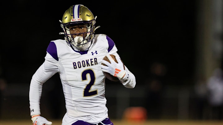 Booker's Tyren Wortham (2) rushes for yards during the first quarter of an FHSAA Class 3A state football semifinal matchup Friday, Dec. 6, 2024 at Raines High School in Jacksonville, Fla.