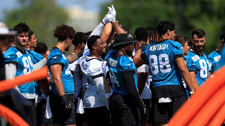 Jacksonville Jaguars linebacker Ventrell Miller (51), center, smiles in a huddle during practice during an organized team activity Tuesday, May 28, 2024 at EverBank Stadium’s Miller Electric Center in Jacksonville, Fla.