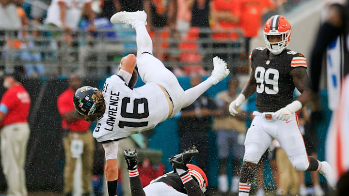 Jacksonville Jaguars quarterback Trevor Lawrence (16) is upended by Cleveland Browns linebacker Jeremiah Owusu-Koramoah (6) as defensive end Za'Darius Smith (99) looks on during the fourth quarter of an NFL football matchup Sunday, Sept. 15, 2024 at EverBank Stadium in Jacksonville, Fla. The Browns defeated the Jaguars 18-13. Jacksonville Jaguars quarterback Trevor Lawrence (16) is upended by Cleveland Browns linebacker Jeremiah Owusu-Koramoah (6) as defensive end Za'Darius Smith (99) looks on during the fourth quarter of an NFL football matchup Sunday, Sept. 15, 2024 at EverBank Stadium in Jacksonville, Fla. The Browns defeated the Jaguars 18-13.