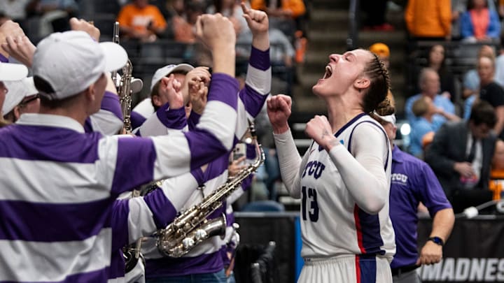 TCU Horned Frogs center Sedona Prince (13) celebrates victory with the marching band as TCU Horned Frogs face off with Notre Dame Fighting Irish during the Sweet 16 at Legacy Arena in Birmingham, Ala., on Saturday, March 29, 2025. TCU Horned Frogs defeated Notre Dame Fighting Irish 71-62 to advance to the Elite 8.