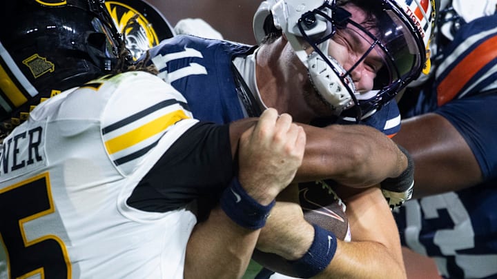 Auburn Tigers quarterback Jackson Arnold (11) is tackled by Missouri Tigers safety Santana Banner (15) as Auburn Tigers take on Missouri Tigers at Jordan-Hare Stadium in Auburn, Ala. on Saturday, Oct. 18, 2025. Missouri Tigers defeated the Auburn Tigers 23-17 in 2OT. Auburn Tigers quarterback Jackson Arnold (11) is tackled by Missouri Tigers safety Santana Banner (15) as Auburn Tigers take on Missouri Tigers at Jordan-Hare Stadium in Auburn, Ala. on Saturday, Oct. 18, 2025. Missouri Tigers defeated the Auburn Tigers 23-17 in 2OT.